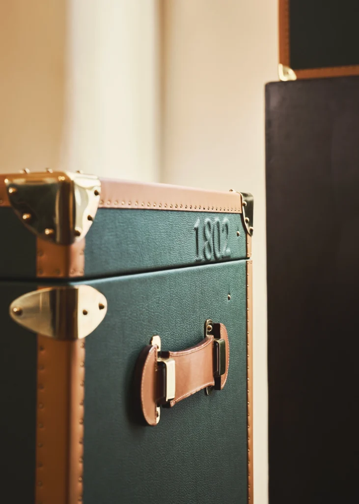 Leather handle and brass hardware on a Henry de Freycinet trunk